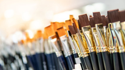 Group of artistic paintbrushes for artist. New paint brushes on shelf display in stationery shop....