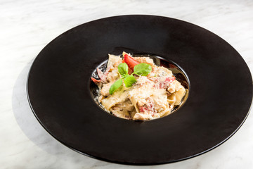 Italian penne pasta with cheese and basil