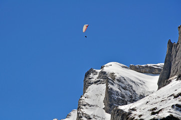 Fototapeta na wymiar paragliding over swiss alps peak