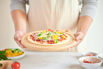 Step-by-step boss makes a pizza margarita. Dough and pizza ingredients