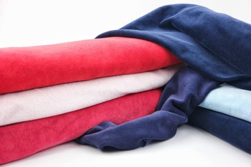 Pink, red, blue, pale blue velvet, fabric roll, white background