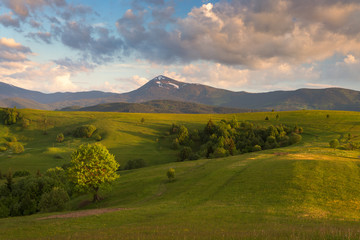 Green spring hills at the foot of the mountain Petros