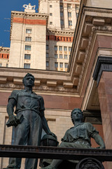 Statue of a man and a woman in front of the main building of MSU. M. V. Lomonosova, Russia