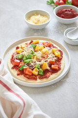 Raw dough for pizza preparation with ingredient: tomato sauce, mozzarella, ...