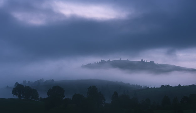 Misty hills at gloomy morning