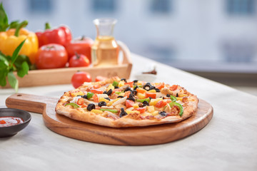 Top view ITALIAN PIZZA on wooden table. True hot tasty PIZZA with salami, mushrooms, basil, olives, pepper and cheese. Nice for menu Pizzeria.