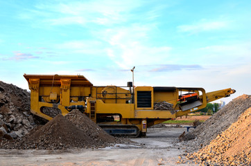 Mobile Stone crusher machine by the construction site or mining quarry for crushing old concrete...