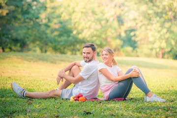 Portrait image of Young couple enjoying in the park at sunset. Concept romantic and love. Warm tone.