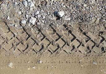 car tire tracks on wet muddy trail royalty, road, abstract background, texture material. Tyre track on dirt sand or mud, retro tone, grunge tone, drive on sand, off road