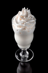 Milkshake. A cool drink of milk, ice cream, chocolate, vanilla, strawberries, on a black background with stones and ice. Cocktail card for a bar or restaurant iisolated on black 