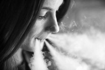 Vaping teenager. Young pretty white girl smoking an electronic cigarette  in vape bar. Bad habit....