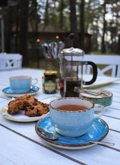 cup of tea and cookies on wooden table