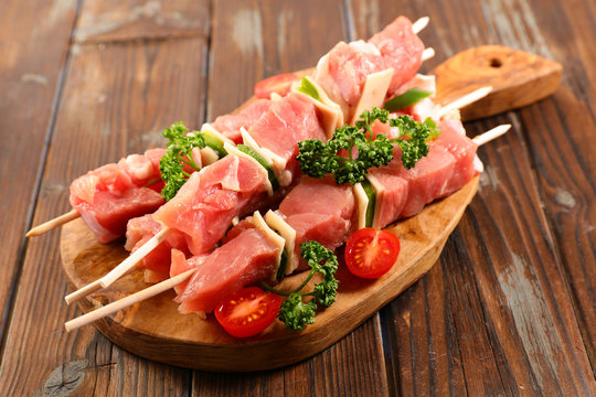 raw meat, skewer on wooden board for barbecue