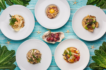 set of pasta at blue wooden background. italian cuisine flat lay. Gourmet food. Delicious restaurant dishes