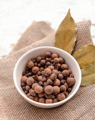 spices sweet peas, Bay leaf. black allspice and cloves in bowl on natural background. spices,...
