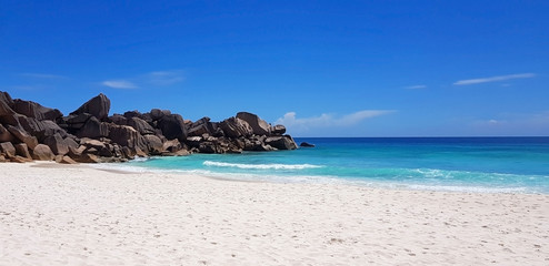 Seychelles with white sand, azure ocean and blue sky. Open place.
