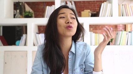 Happy asian girl student looking at camera making video call - Powered by Adobe