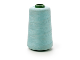 spools of thread for the textile industry on white background