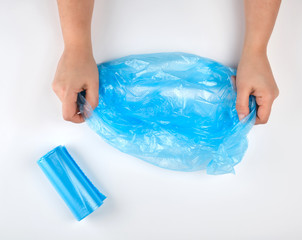blue plastic garbage bag in hands