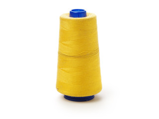 spools of thread for the textile industry on white background