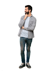 Handsome man with beard looking to the side over isolated white background