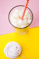 White sugar cubes in a glass with tubule