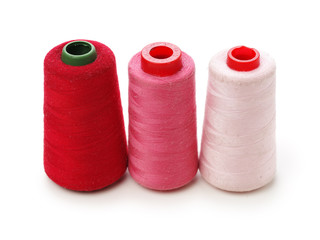 spools of thread for the textile industry on white background