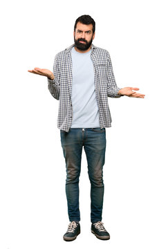 Handsome man with beard unhappy for not understand something over isolated white background