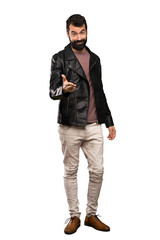 Fototapeta premium Handsome man with beard shaking hands for closing a good deal over isolated white background