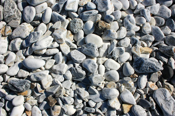 White smooth stones on the seashore