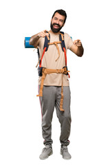Naklejka premium Hiker man points finger at you while smiling over isolated white background