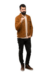 Fototapeta premium Handsome man with beard frustrated and pointing to the front over isolated white background