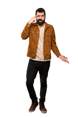 Fototapeta premium Handsome man with beard making the gesture of madness putting finger on the head over isolated white background