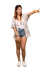 Full-length shot of Young woman in bikini in summer holidays pointing away over isolated white background
