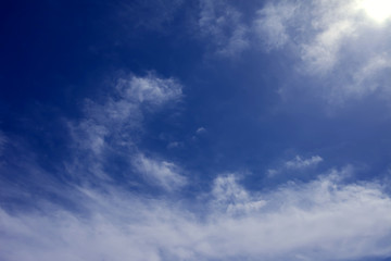 Fototapeta premium A deep blue sky with light white clouds background