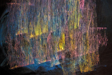 lines of yellow, blue, pink, drawn in chalk on a black chalkboard