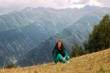Fototapeta na wymiar Beautiful woman traveler relaxing near mountain in Svaneti in Georgia. Vacation concept.