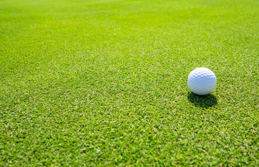 Golf Course with Golf Ball on putting green. Golf is a sport to play on the turf.