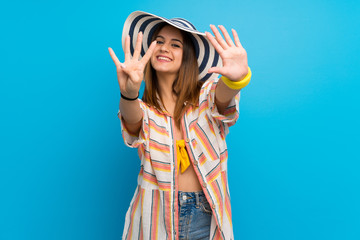 Young woman in bikini in summer holidays counting nine with fingers