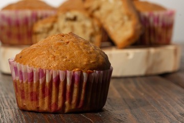 Vanilla cupcake, homemade pastry on wooden background