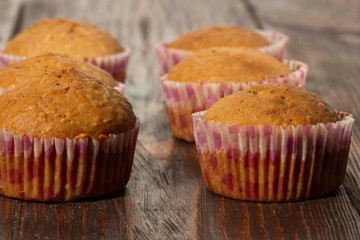 Vanilla cupcake, homemade pastry on wooden background