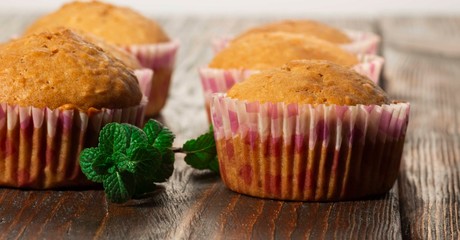 Vanilla cupcake, homemade pastry on wooden background