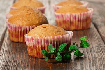 Vanilla cupcake, homemade pastry on wooden background