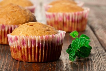 Vanilla cupcake, homemade pastry on wooden background