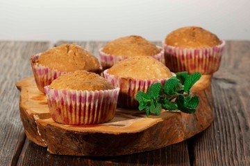Vanilla cupcake, homemade pastry on wooden background