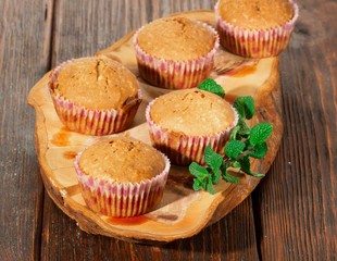 Vanilla cupcake, homemade pastry on wooden background