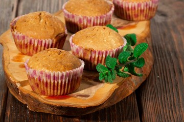 Vanilla cupcake, homemade pastry on wooden background