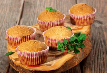 Vanilla cupcake, homemade pastry on wooden background