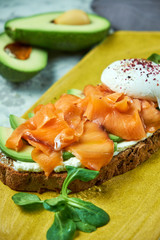 On a light gray background is a yellow plate with brockett. Beautiful serving of dishes. Restaurant menu