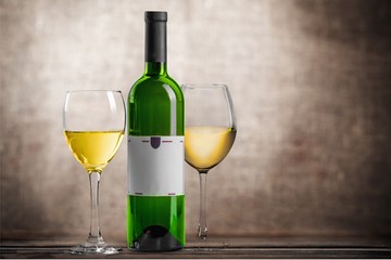Red wine glass and buttle on wooden desk background